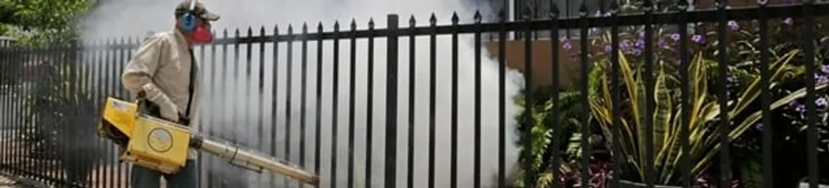 Mosquito control technician fogging a yard perimeter for mosquito reduction in Bellevue, WA